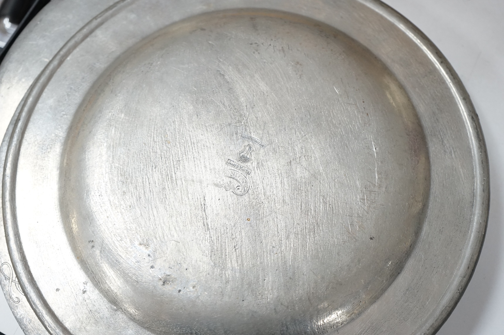 Two 19th century pewter chargers and a set of six pewter plates, largest 42cm in diameter